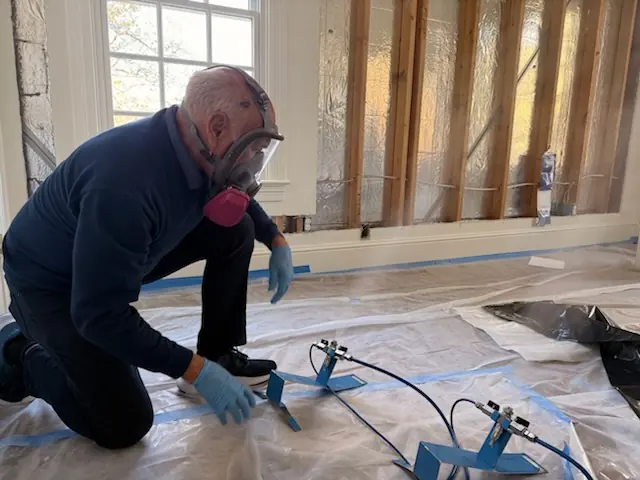 A restoration technician setting drying equipment in a Atlanta home stripped to the studs