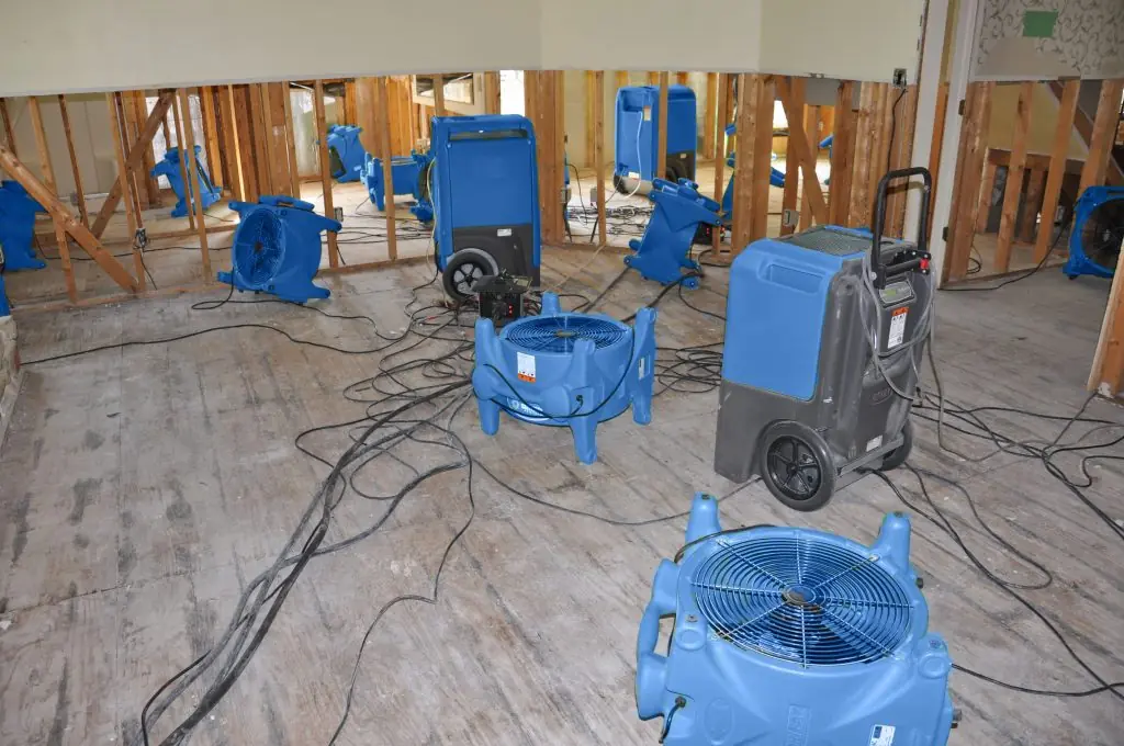 Air movers drying a gutted Atlanta room after major water damage